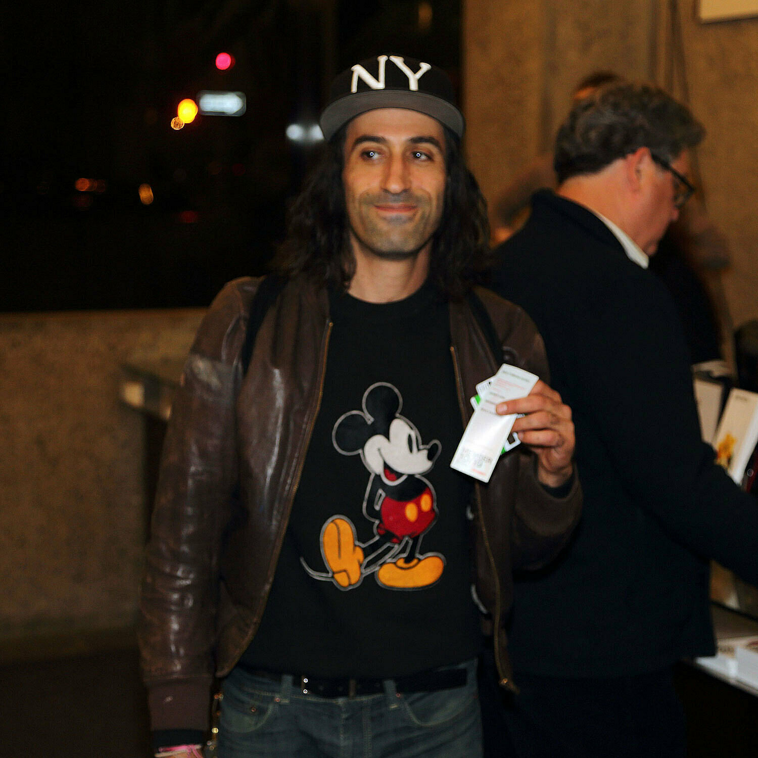 Man in a Mickey Mouse shirt with a ticket.