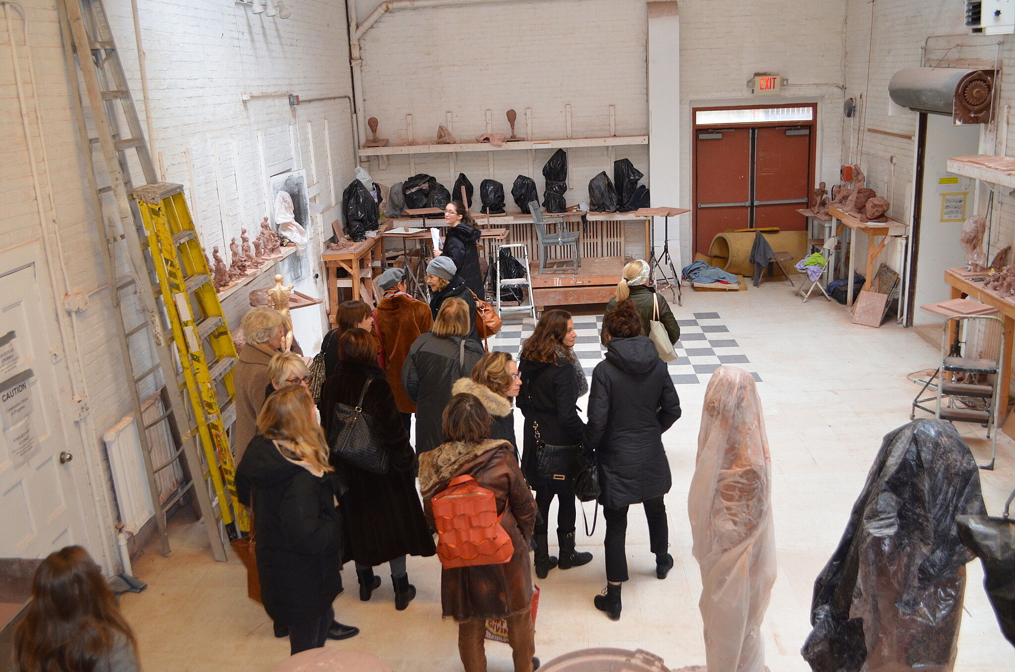 A group tours a sculpture studio