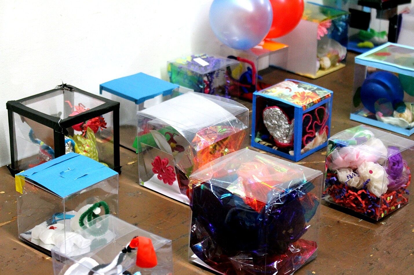 a table full of colorful transparent boxes