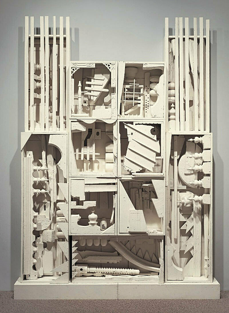 A sculpture of various wood compartments and angular shapes.