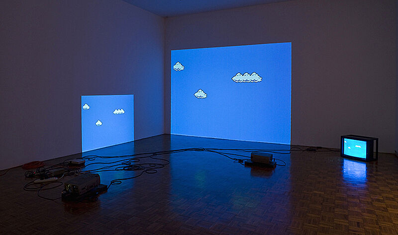 An installation of projections on the wall of animated clouds in the sky.