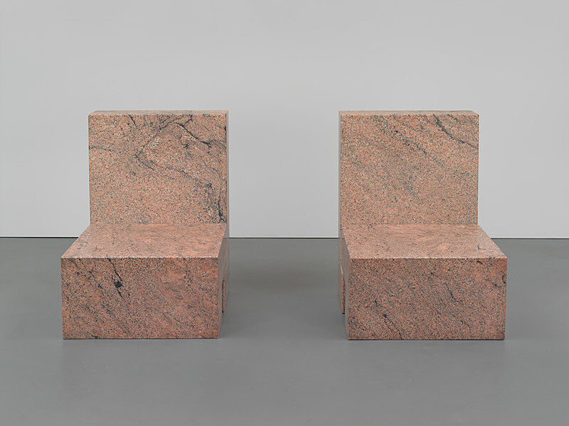 Two granite sculpture chairs.