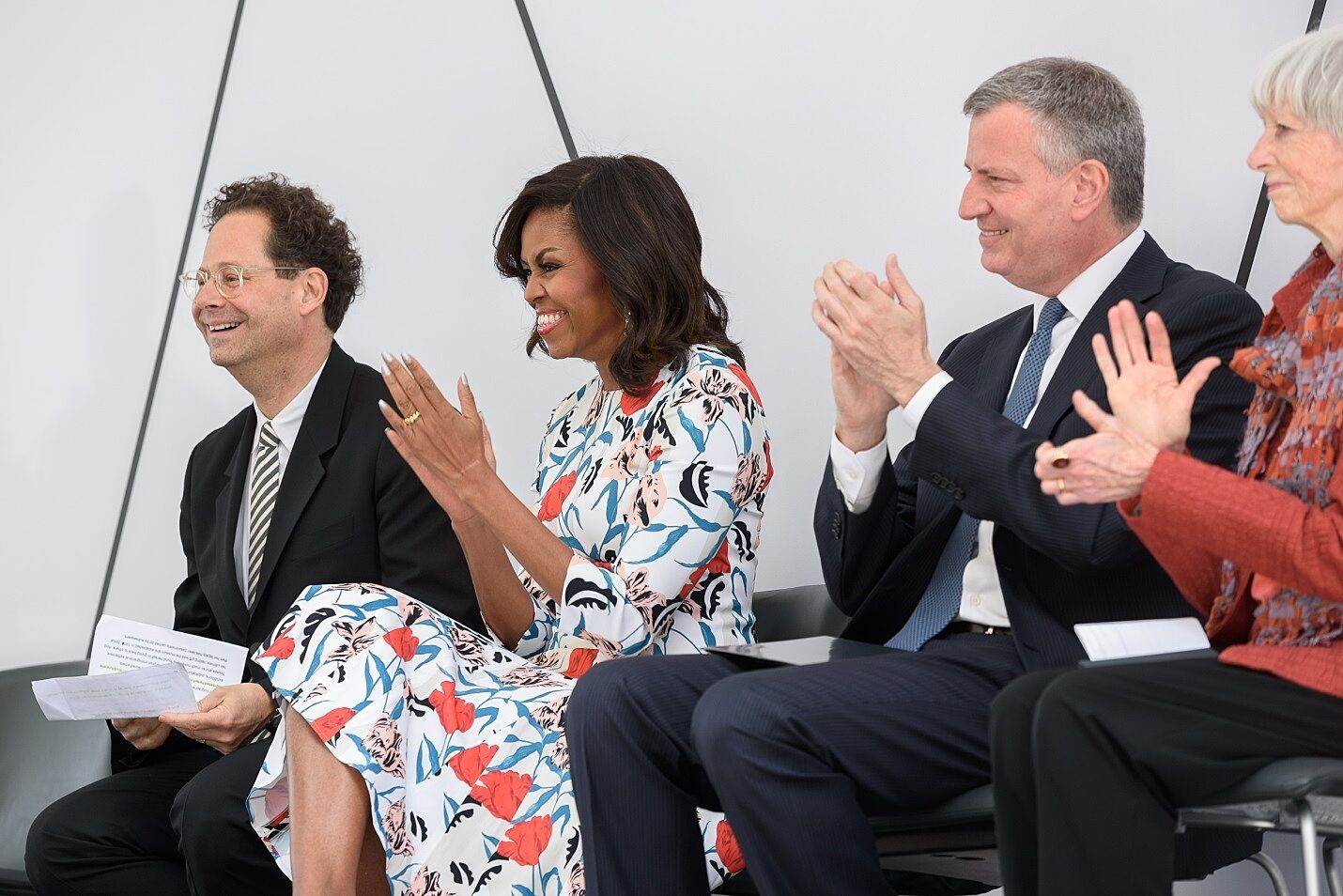 The museum director Adam Weinberg sits with Michell Obama and Mayor DeBlasio.