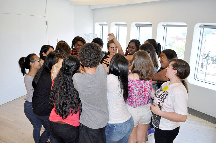 students in a tight circle playing a game