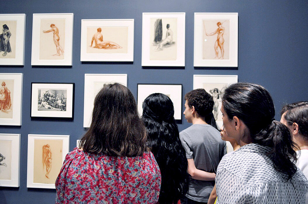 teens looking at sketches on wall