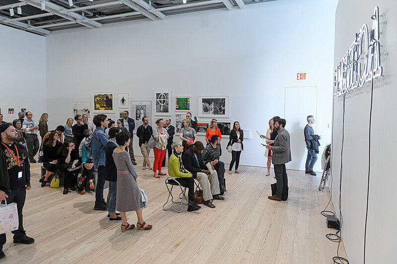 People viewing artworks in a gallery.