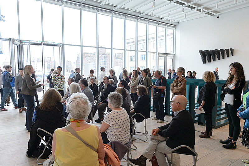 People gathered for a talk in the gallery.