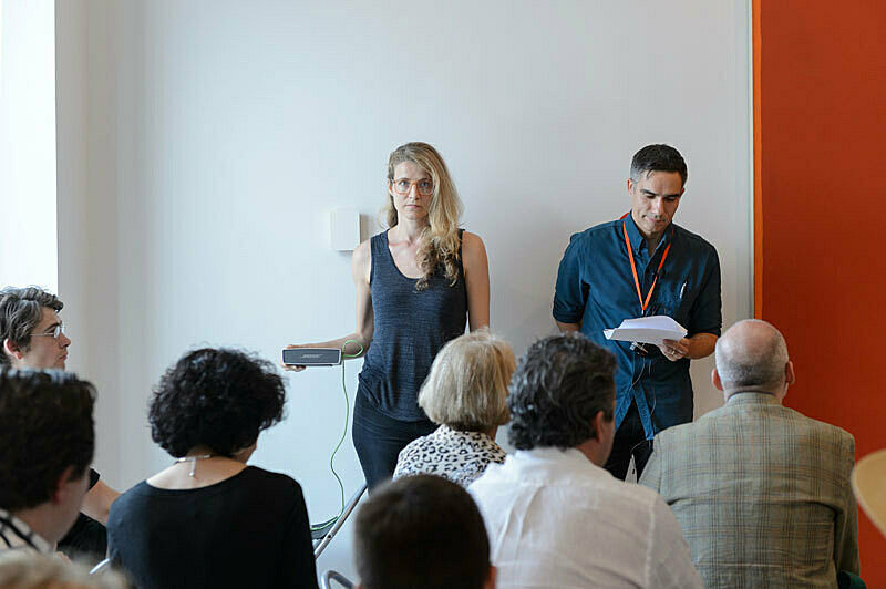 People gathered for a talk in the gallery.