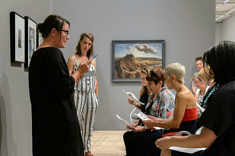 People gathered for a talk in the gallery.