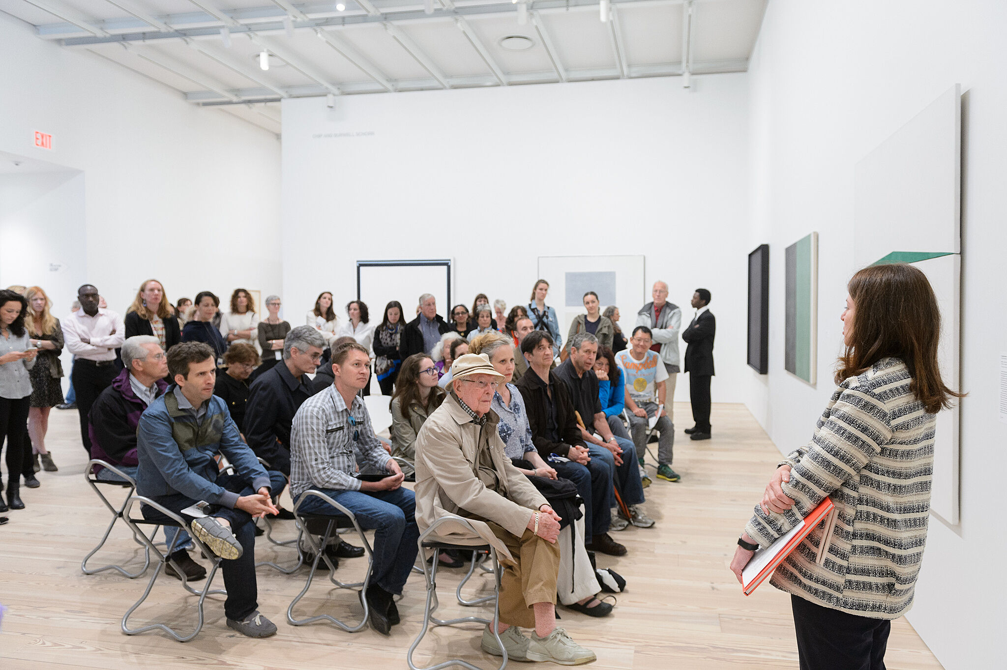 People gathered for a talk in the gallery.