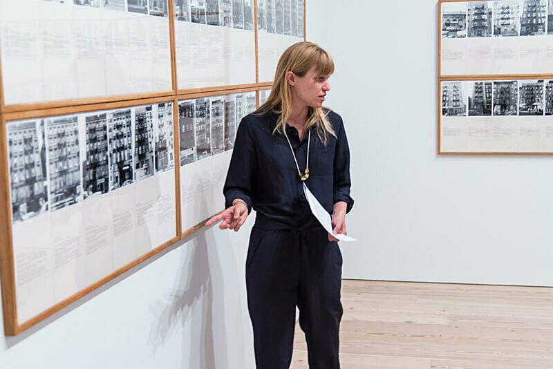 A person discussing artwork in a gallery.