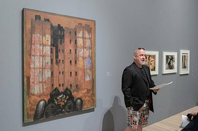 A person discussing artwork in a gallery.