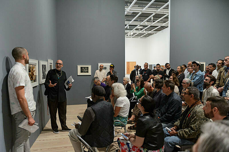 People gathered for a talk in the gallery.