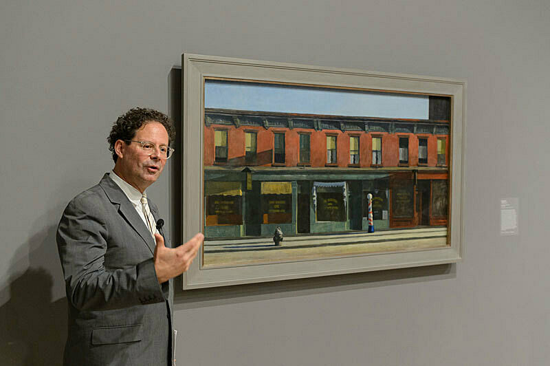 A person discussing artwork in a gallery.
