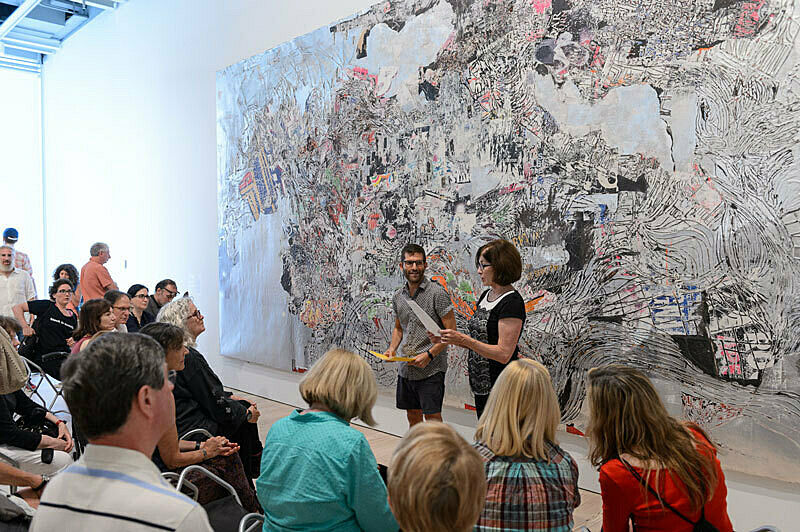 People gathered for a talk in the gallery.