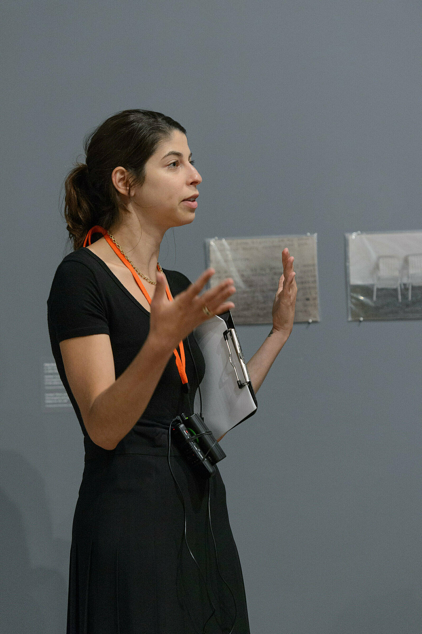 A person discussing artwork in a gallery.
