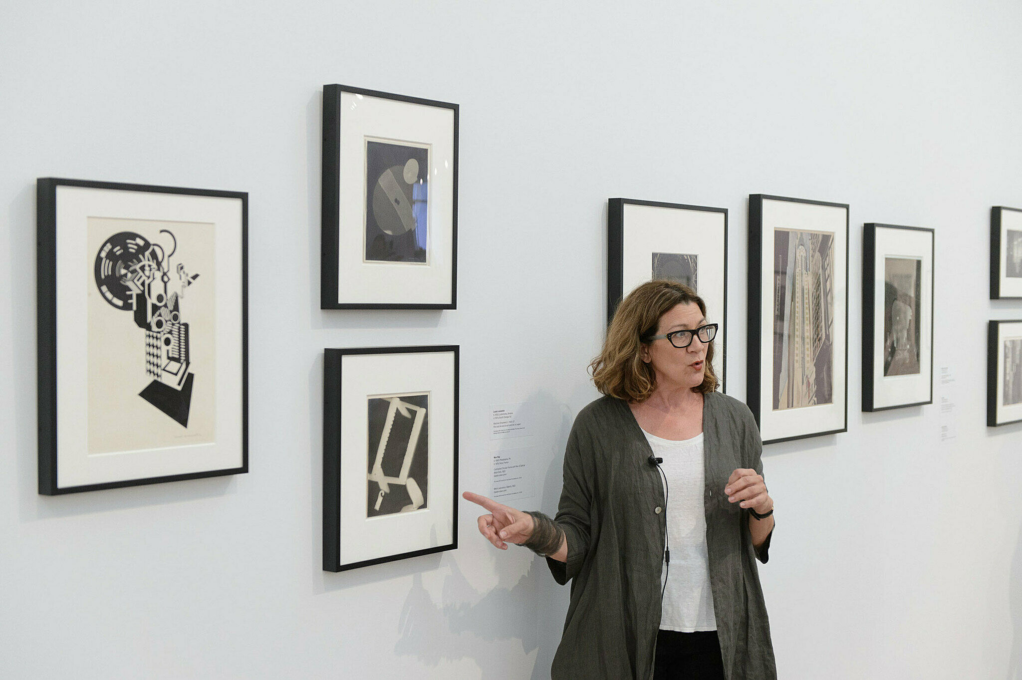 A person discussing artwork in a gallery.