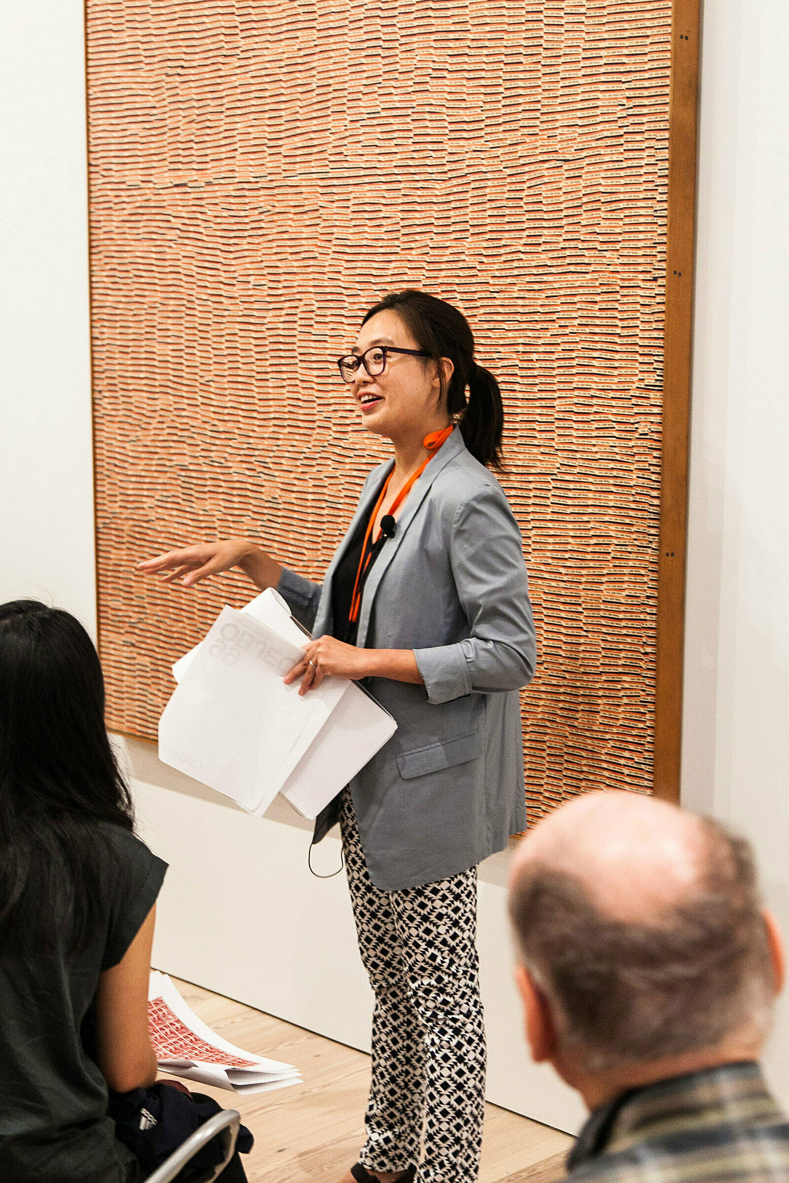 A person discussing artwork in a gallery.