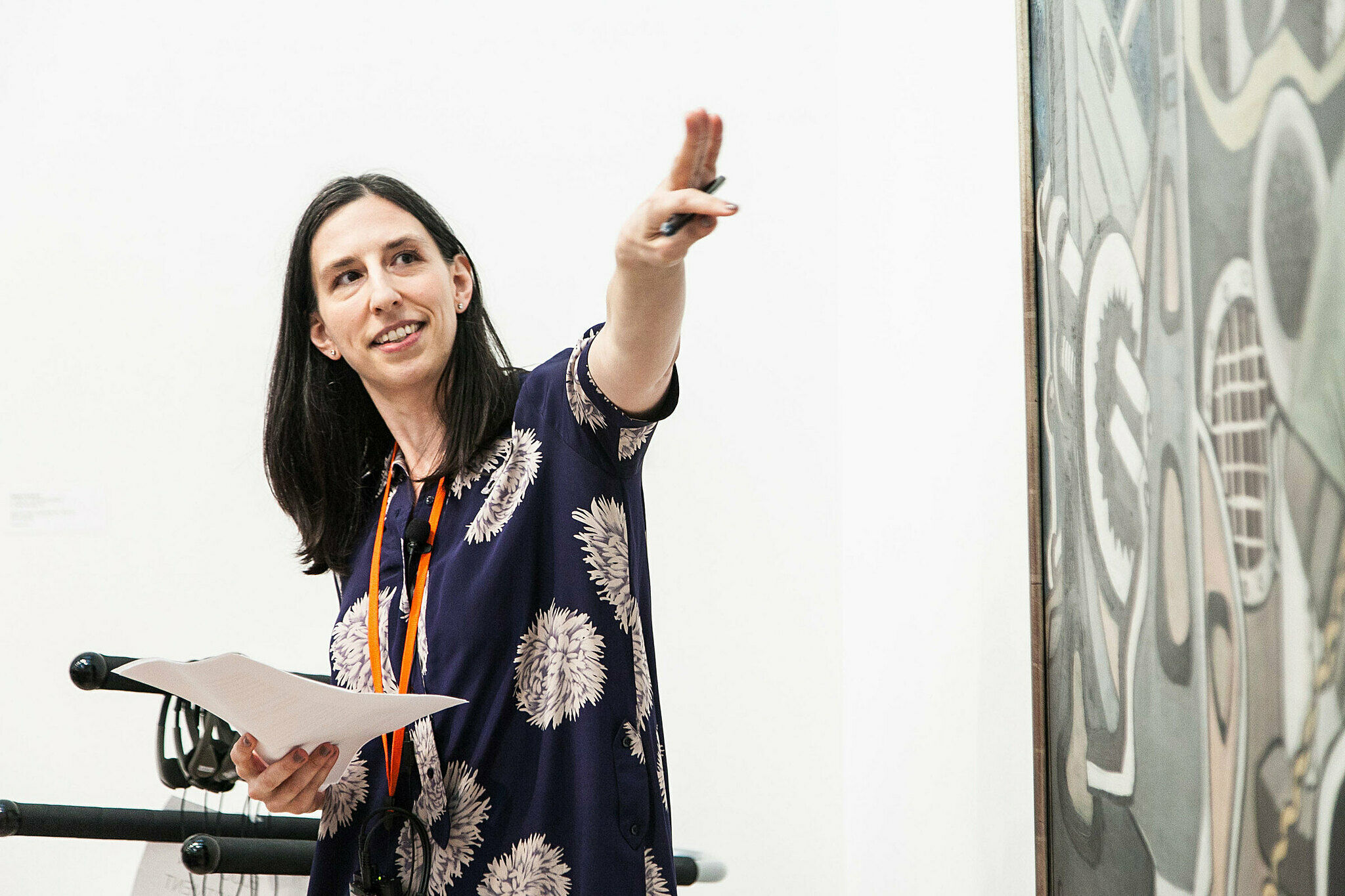 A person discussing artwork in a gallery.