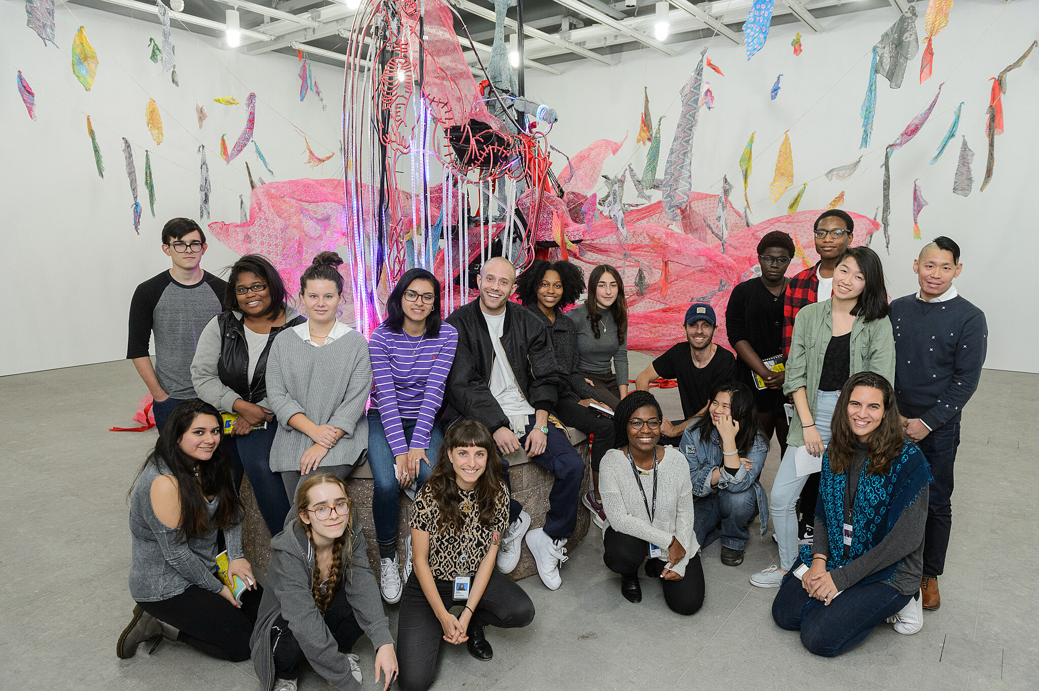 Students pose with artist Jared Madere in the gallery