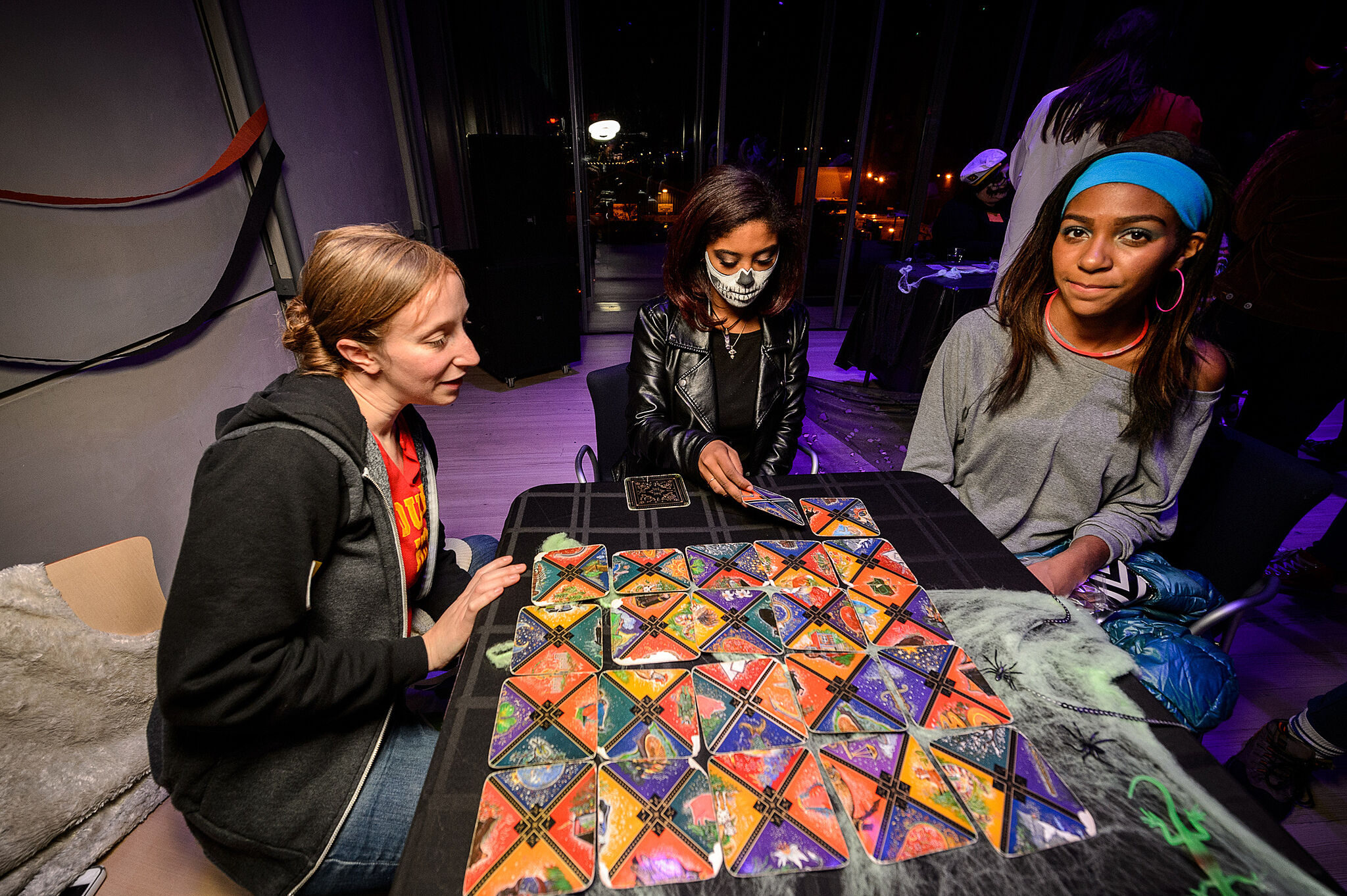 Three teens work on an art project during the party.