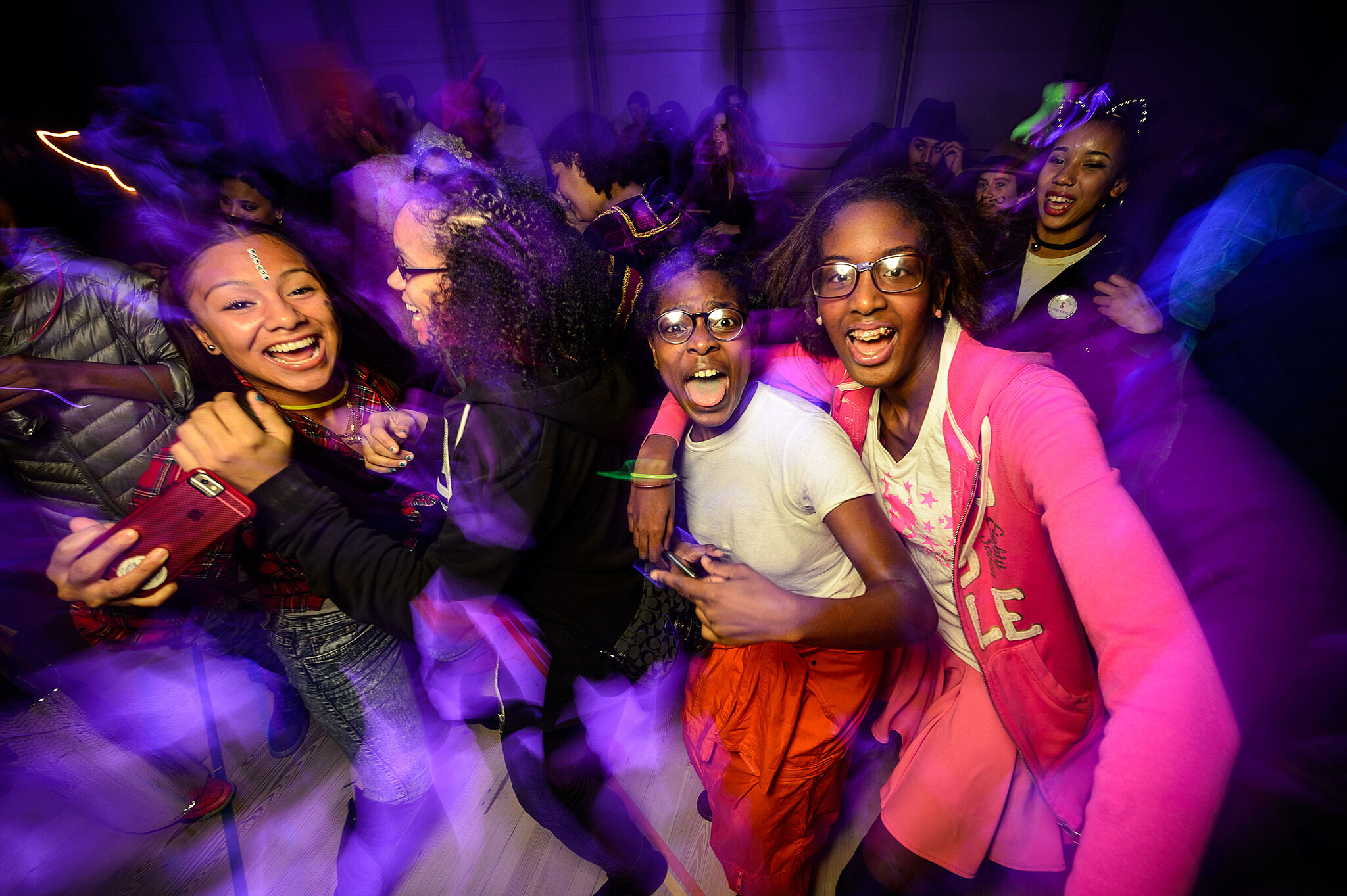 Students dance together during a Halloween event.