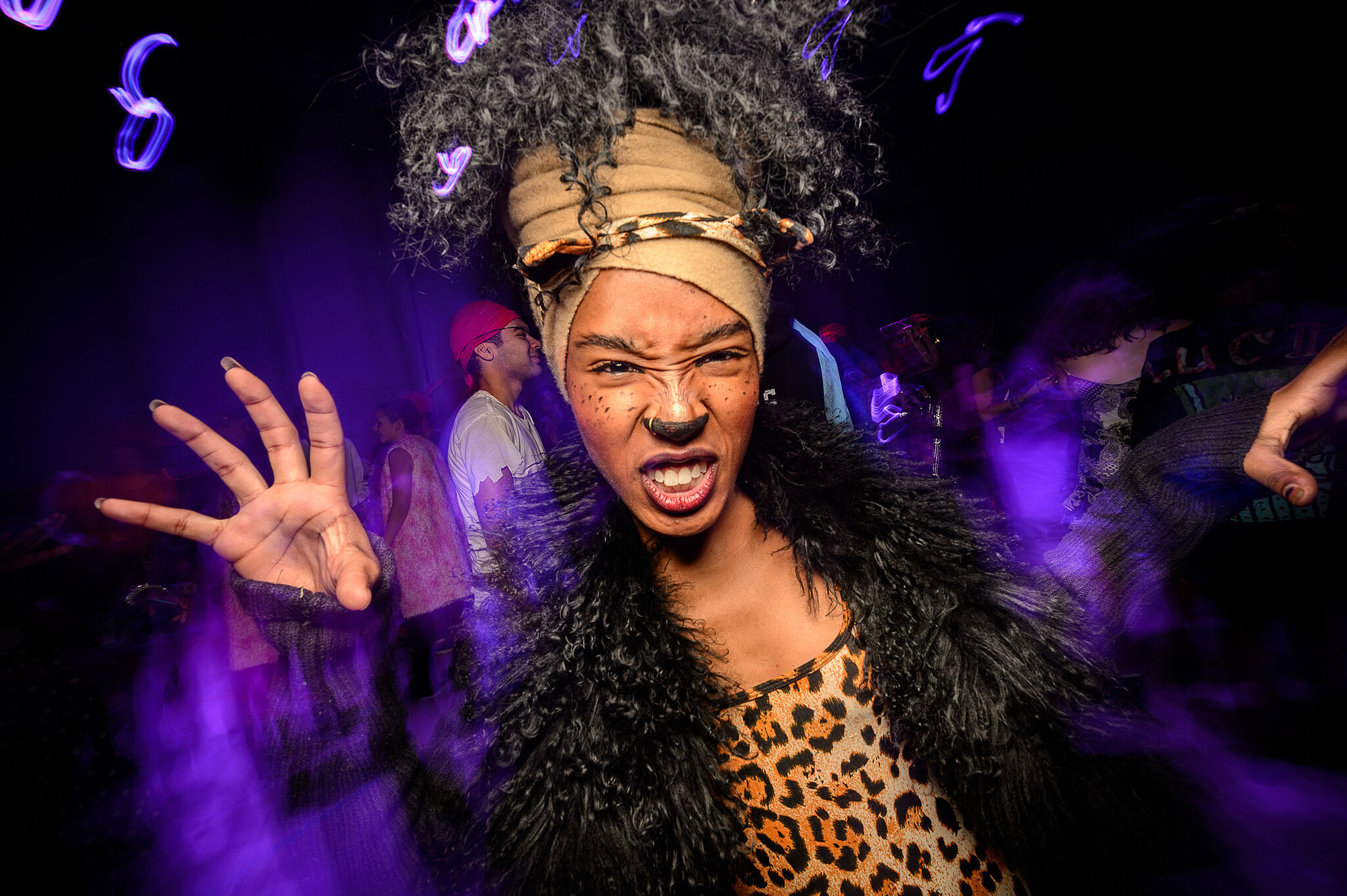 A teen poses for the camera dressed up as a tiger.