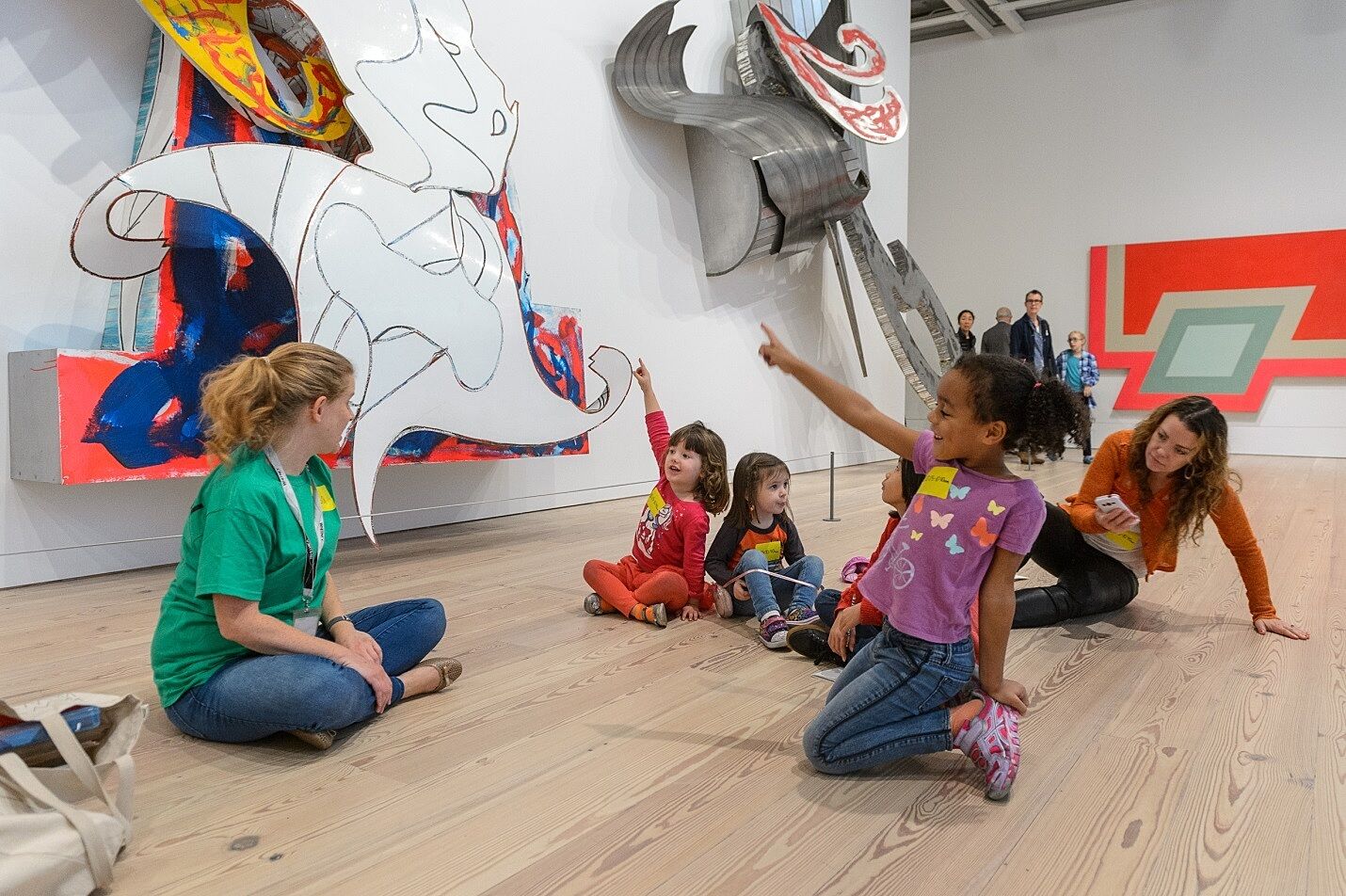 Kids point to a work by Frank Stella in the gallery.