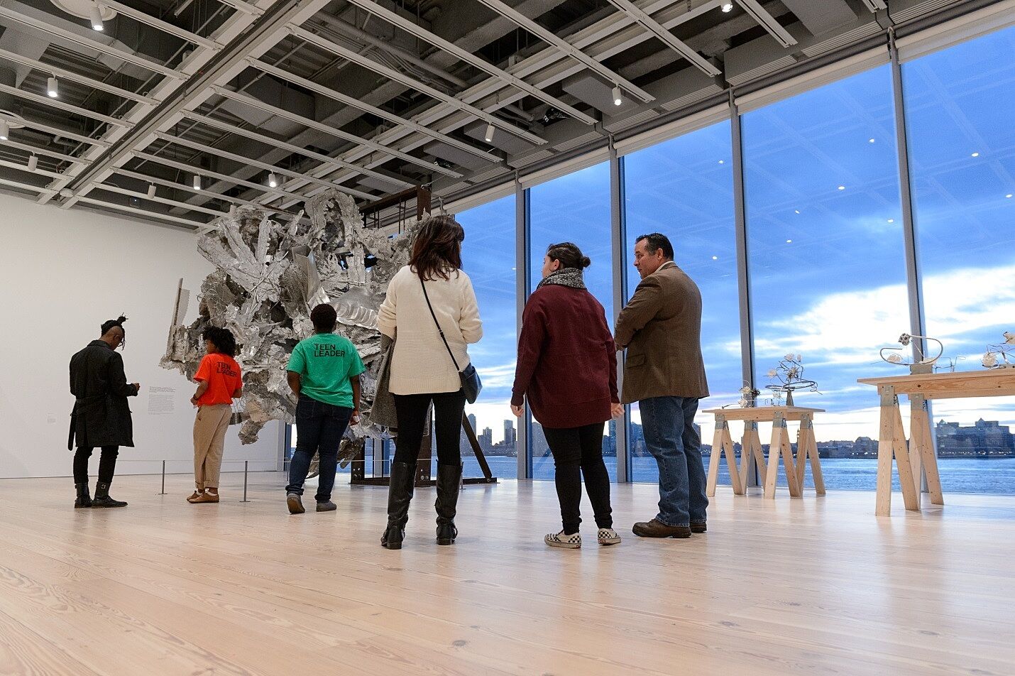 teens and adults in large gallery with big window