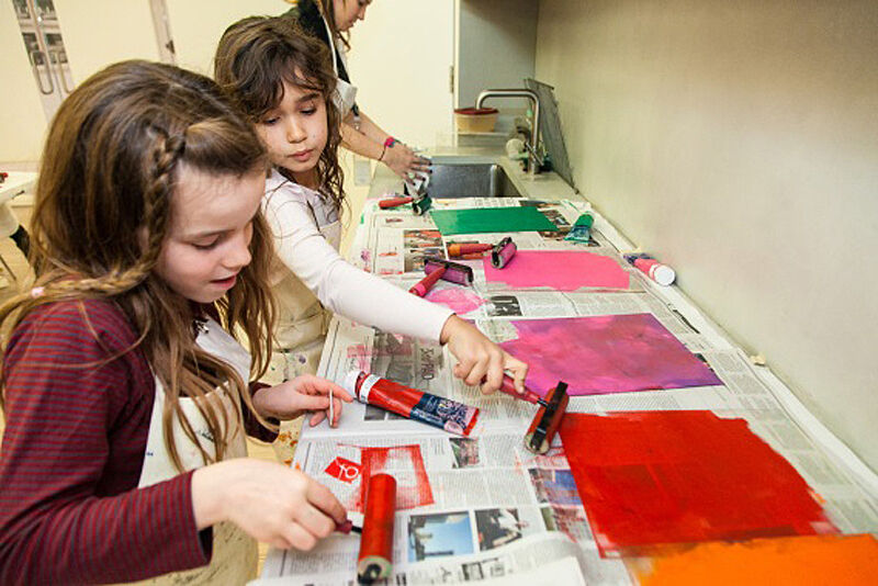 Two girls using paint for printmaking