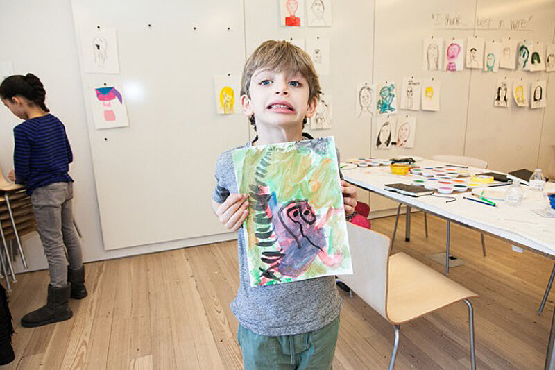 A boy displays his art
