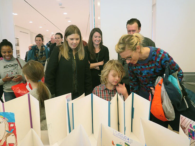 Families see their child's art during a reception