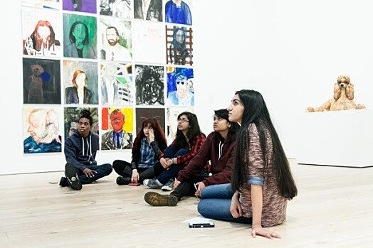 Students sit in the museum