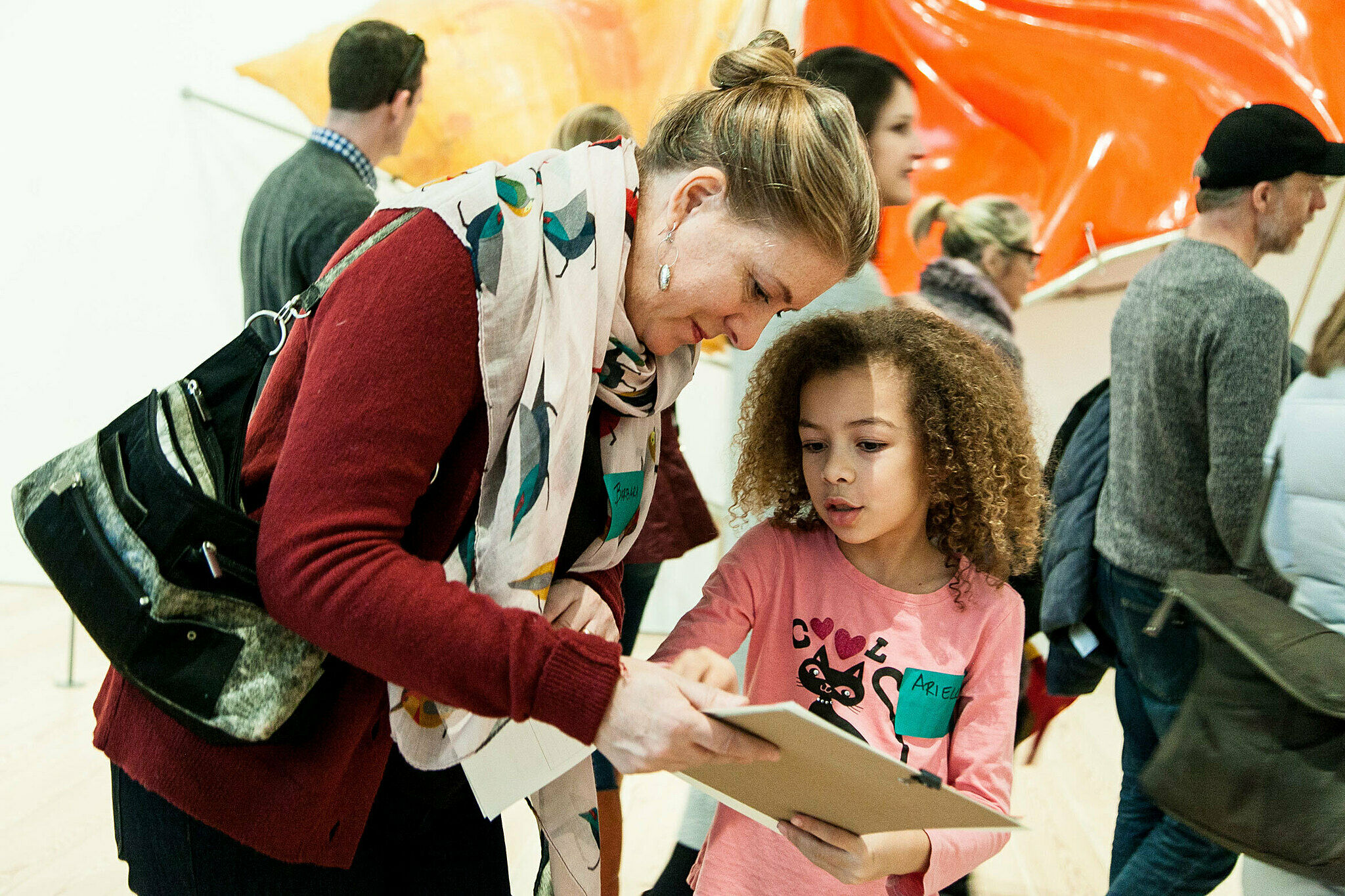 A Mother and child look at a sketchpad in the galleries