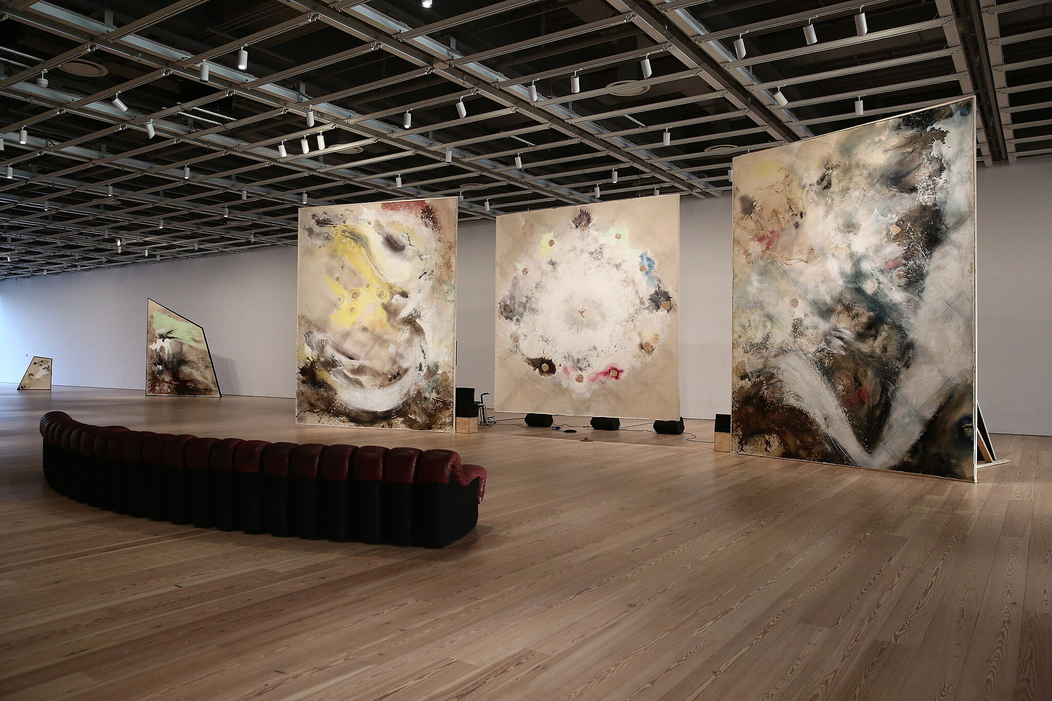 Paintings and couches form a lounge in Lucy Dodd's installation.