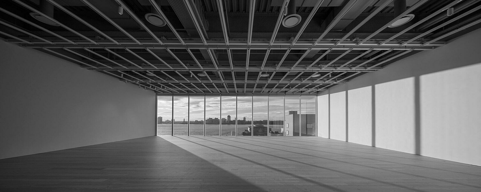 A view of the empty fifth floor Whitney galleries in black and white.
