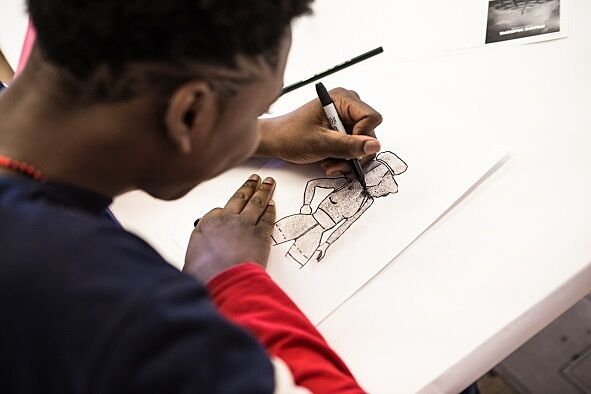 A student practices their drawing technique