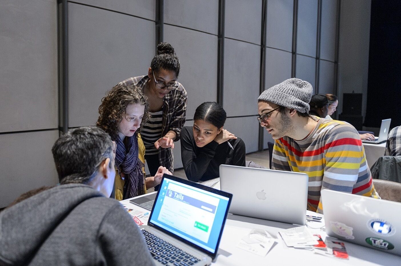 Group participants work at laptops.