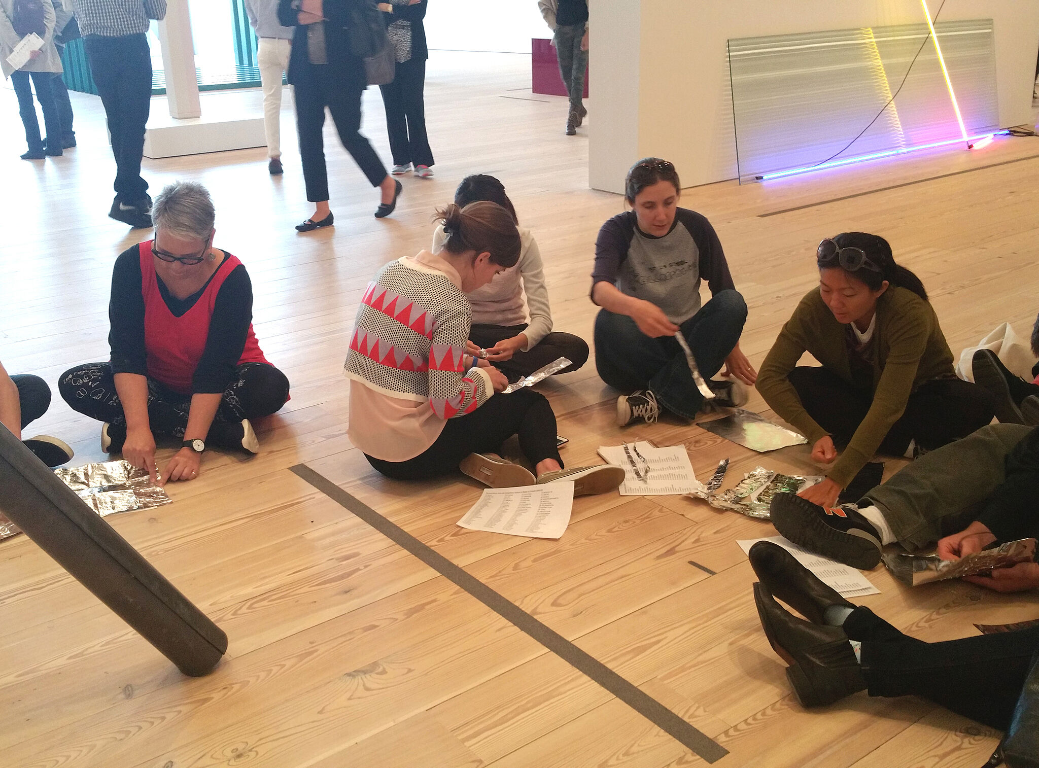Teachers sitting on the floor of a gallery