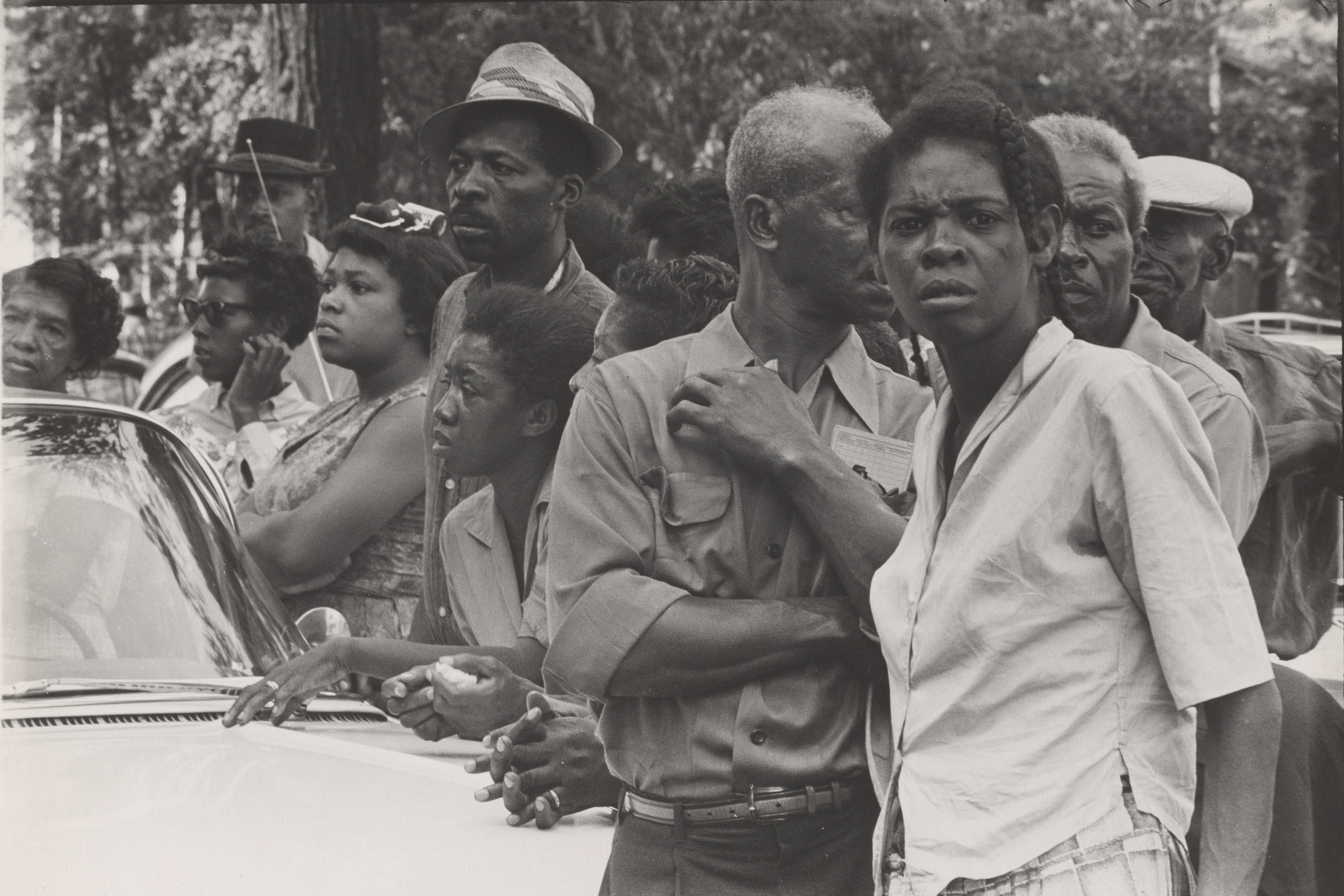 A photograph of a crowd along a funeral procession.