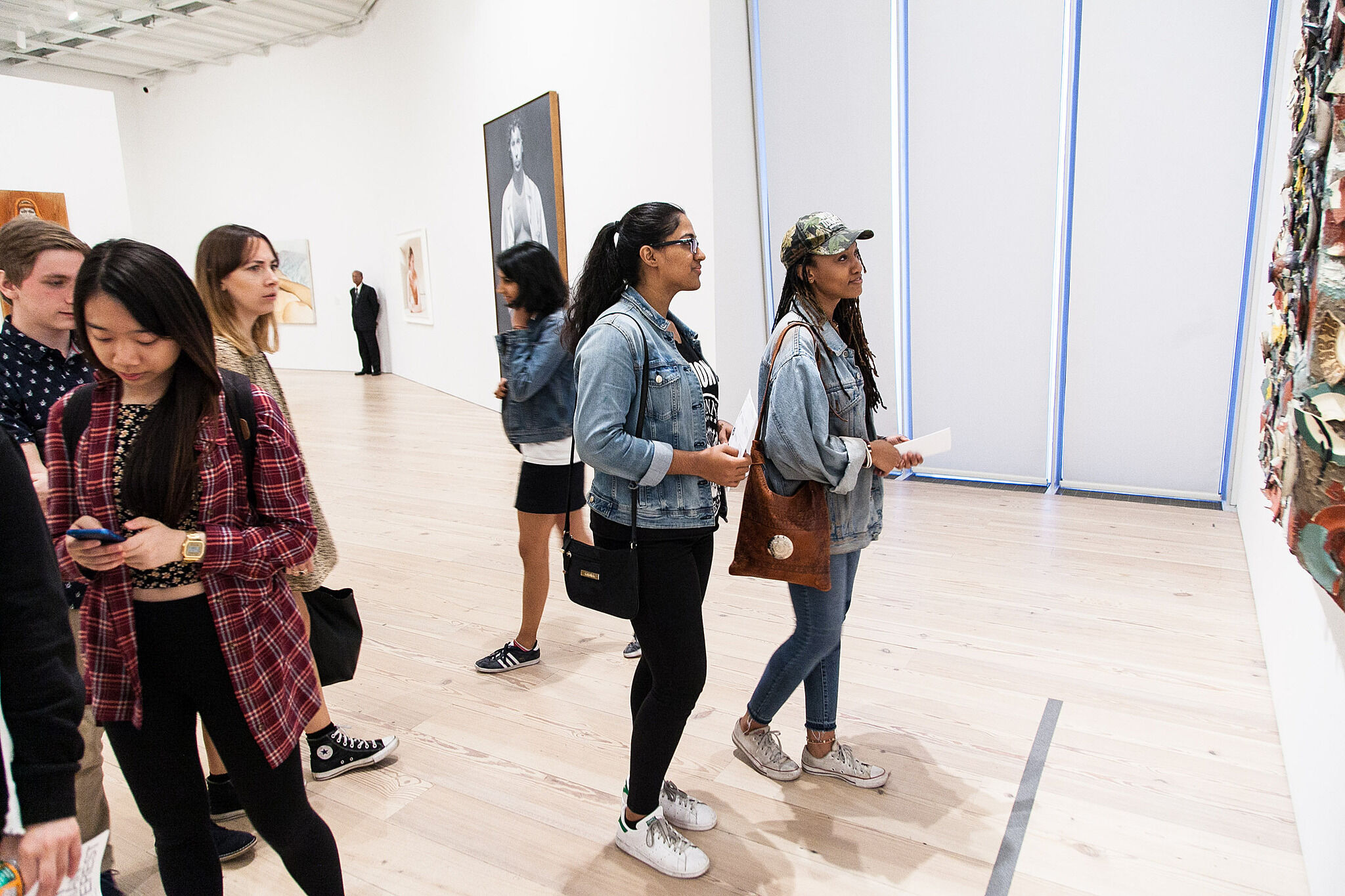 Students use their smartphones in the gallery