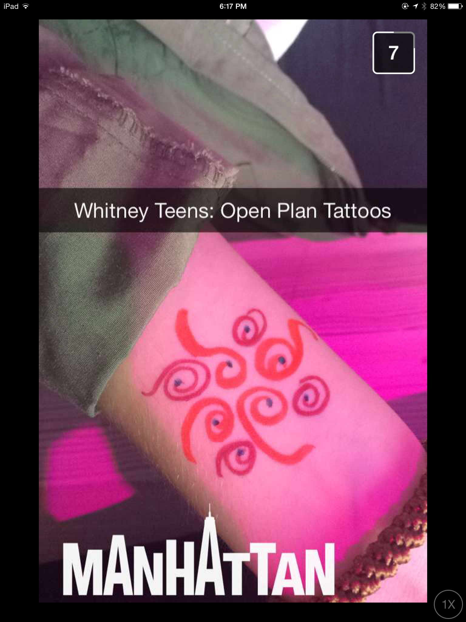 A teen shows off their tattoo