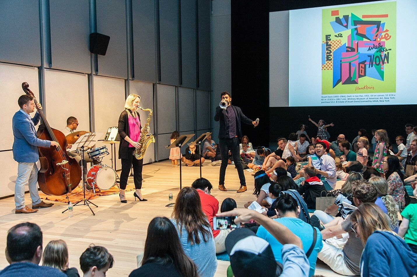 A jazz band performs for children