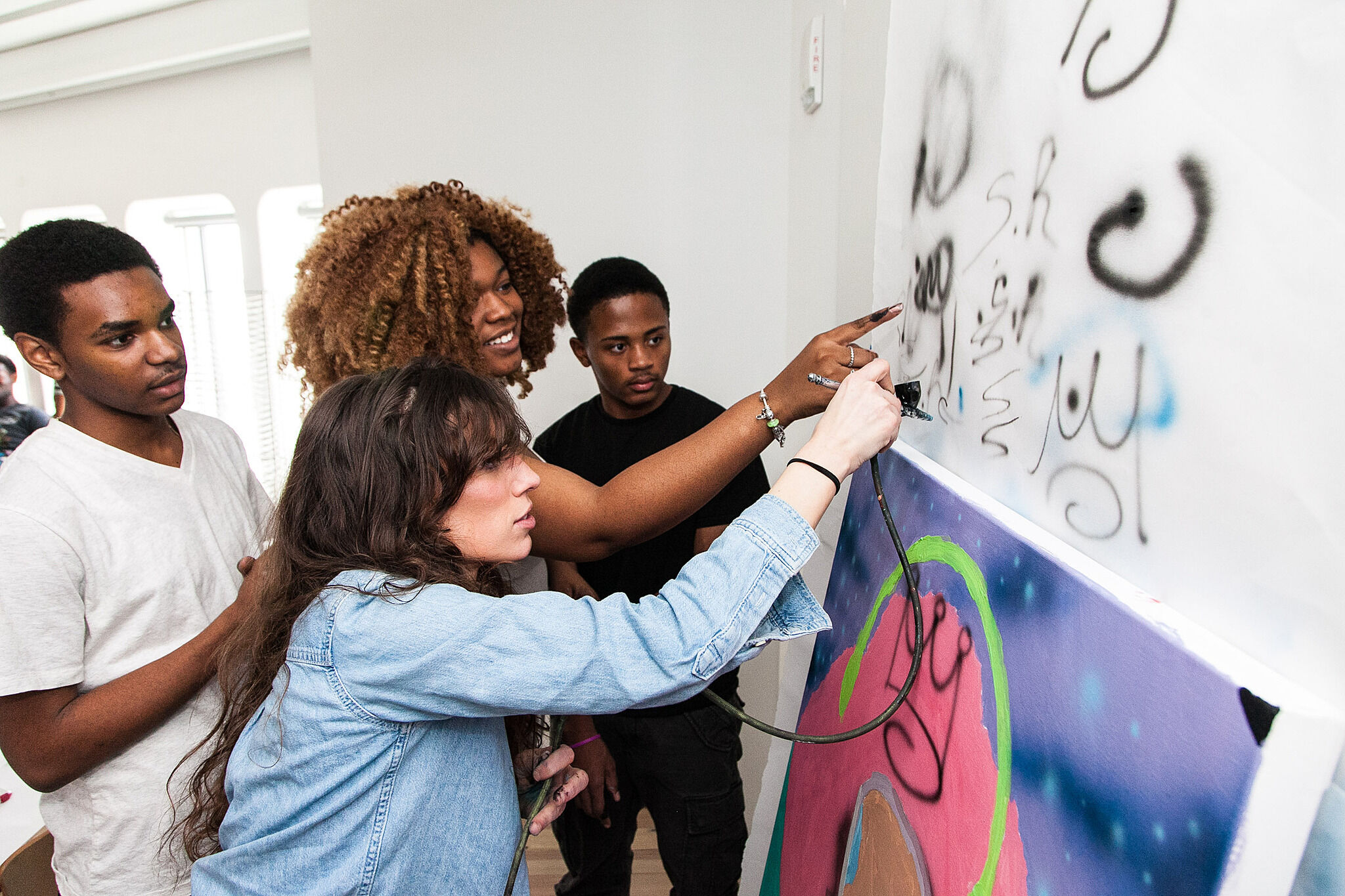 High sschool students looking at spray paint art