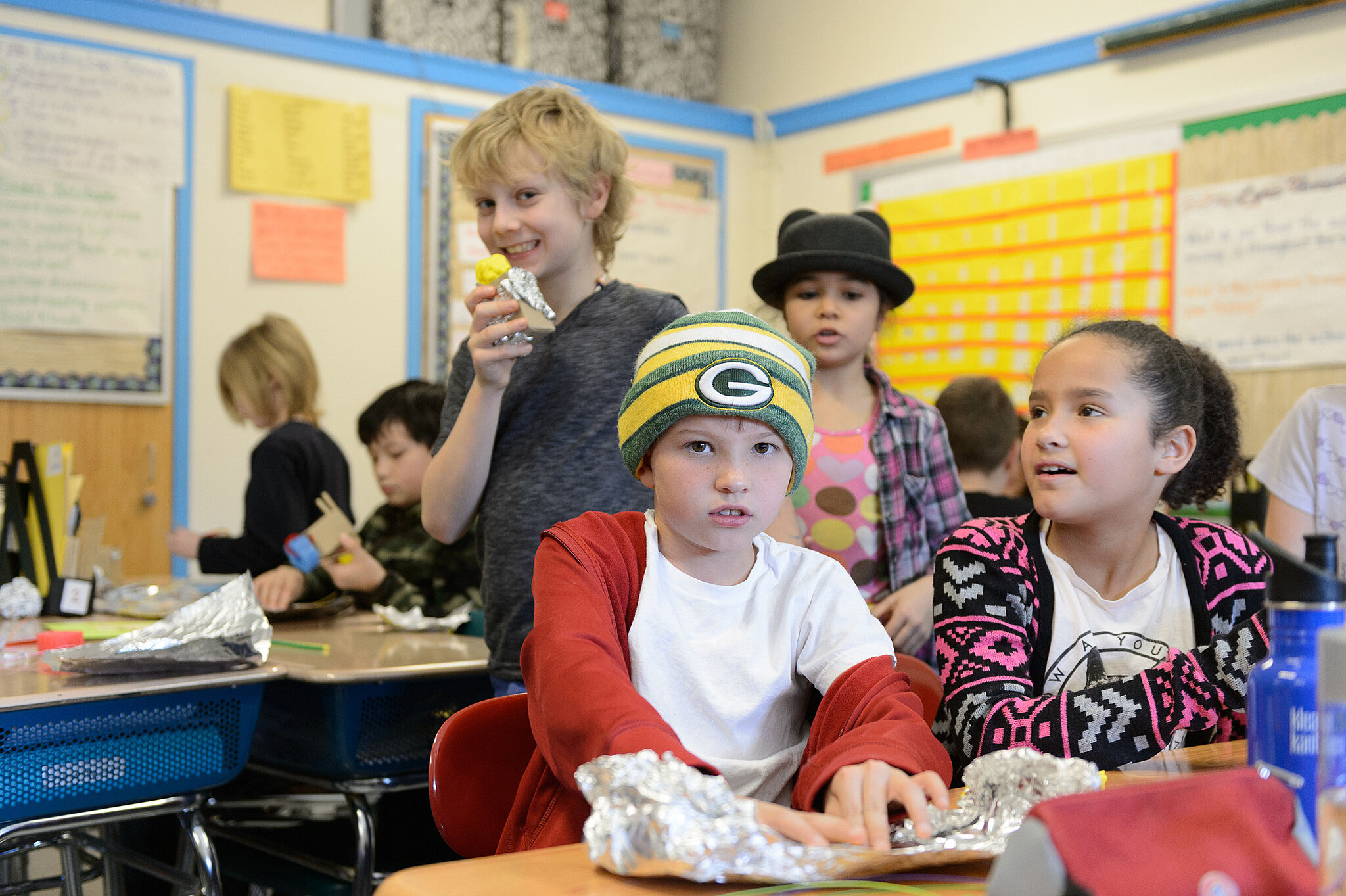 students are standing and sitting smiling