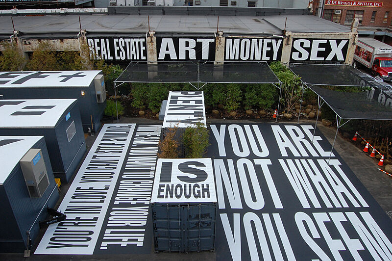 Cargo boxes with giant words on them: You are not what you seem. Real Estate. Art. Money. Sex.