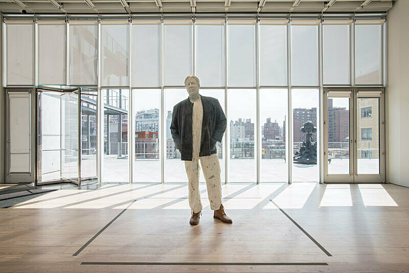 A wax sculpture of a standing man.