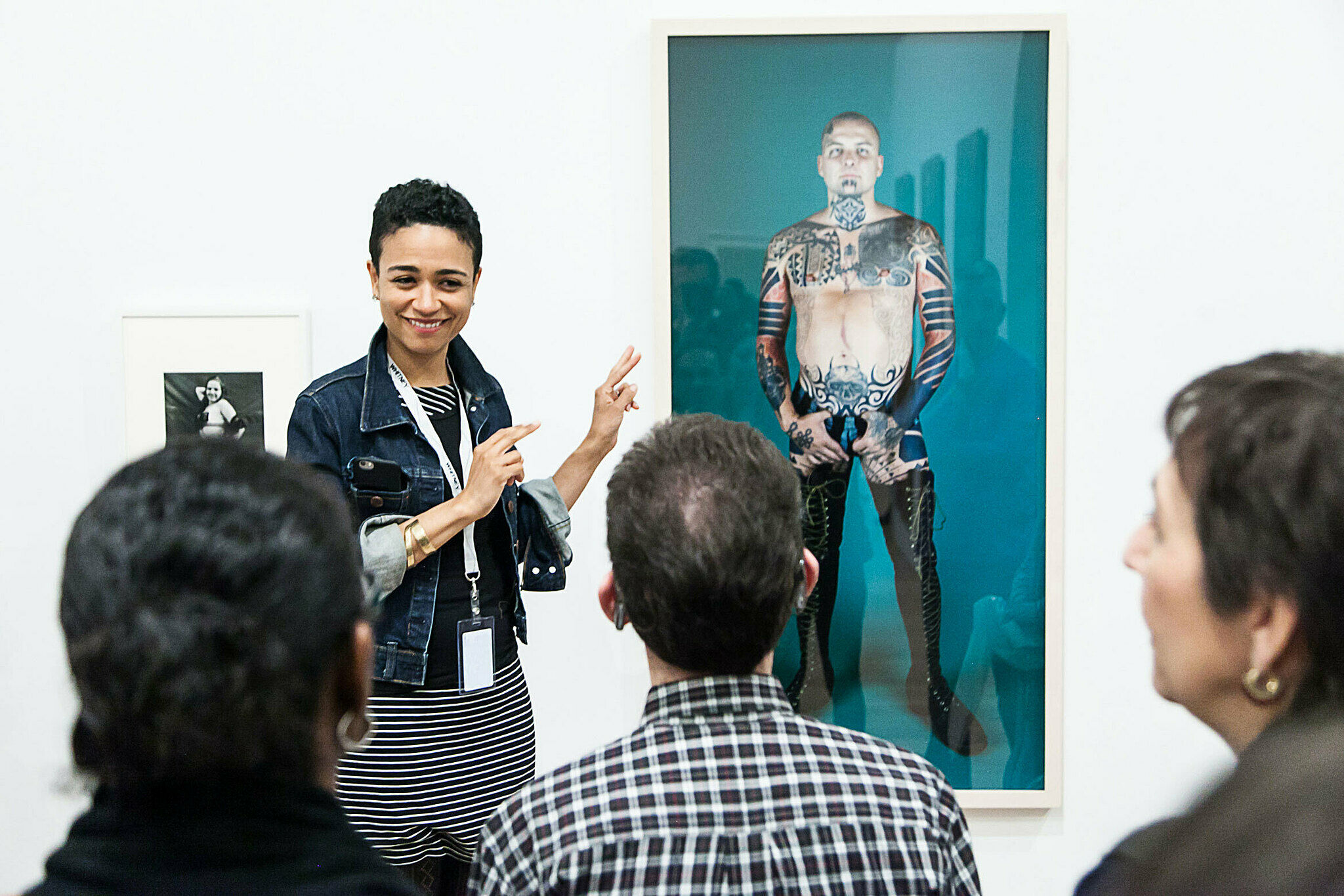 A woman in front of an artwork giving a Whitney Signs tour, 2013