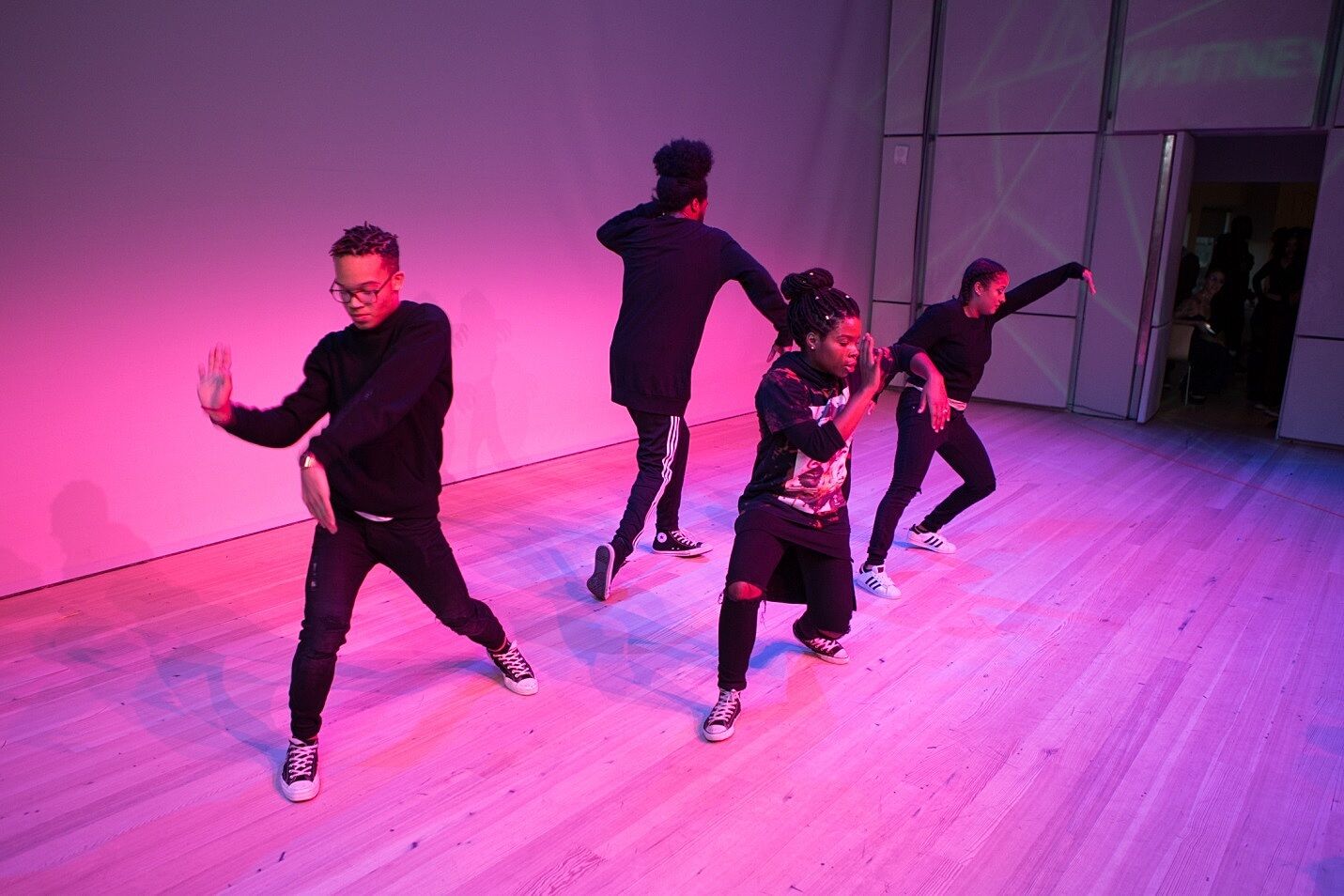 Teens perform on stage.