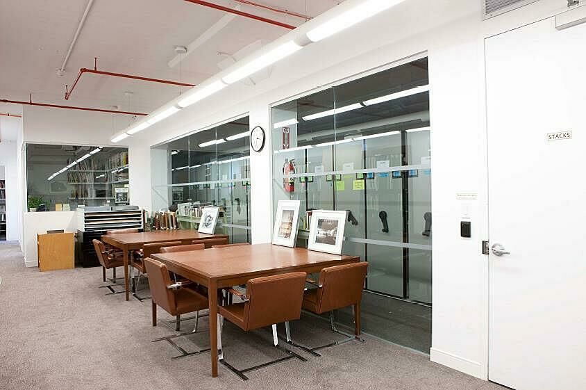 Two tables in front of the Museum library stacks
